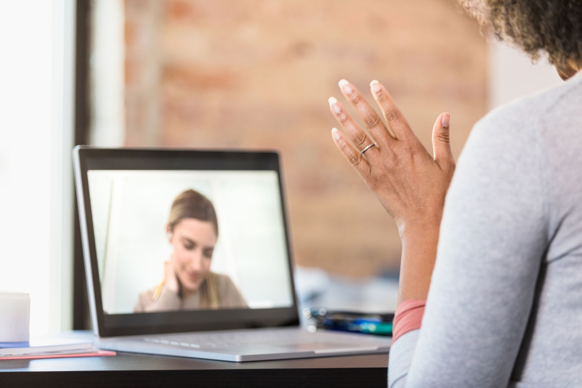 Teacher gestures while helping frustrated online student