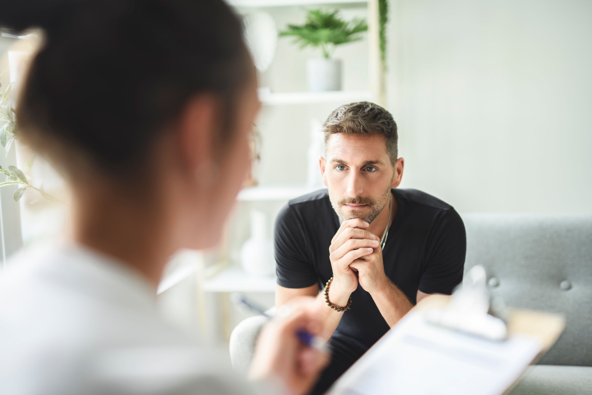 Man with psychologist theraphy social problems concept drug addiction talk to a psychological woman