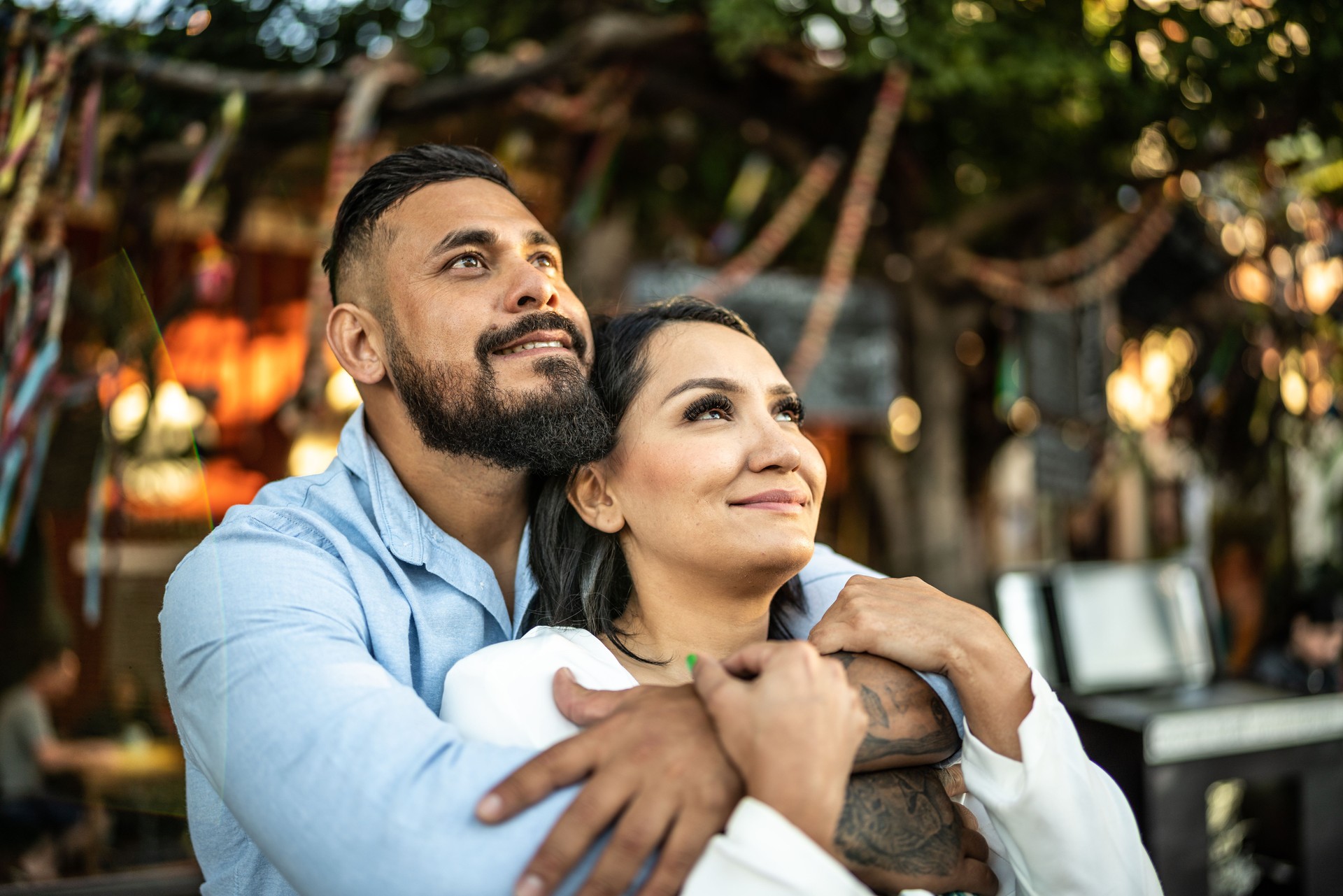 Mid adult couple embracing and contemplating outdoors