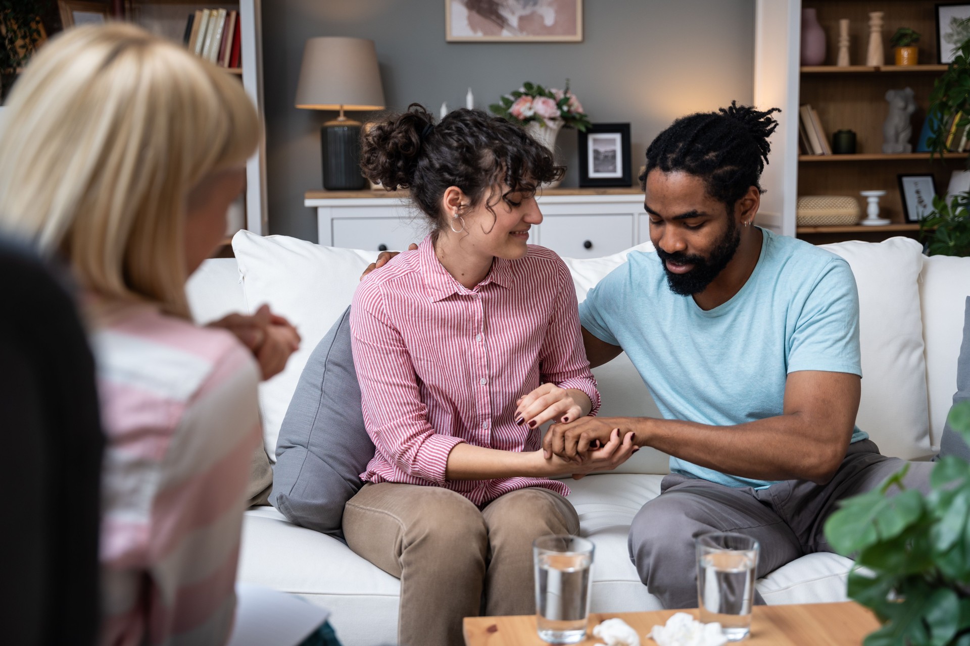Young married couple successfully reconciled and saved their relationship after several visits and discussions with a psychologist at psychotherapy and marriage counseling.